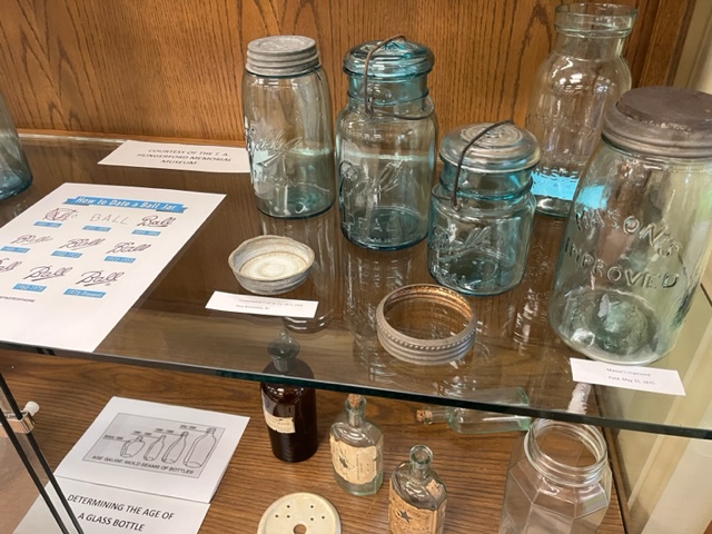 display of antique jars and bottles