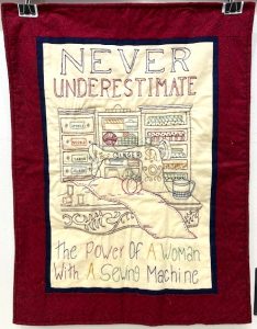 quilt saying: never underestimate the power of a woman with a sewing machine
