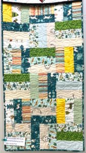 quilt in shades of green and blue